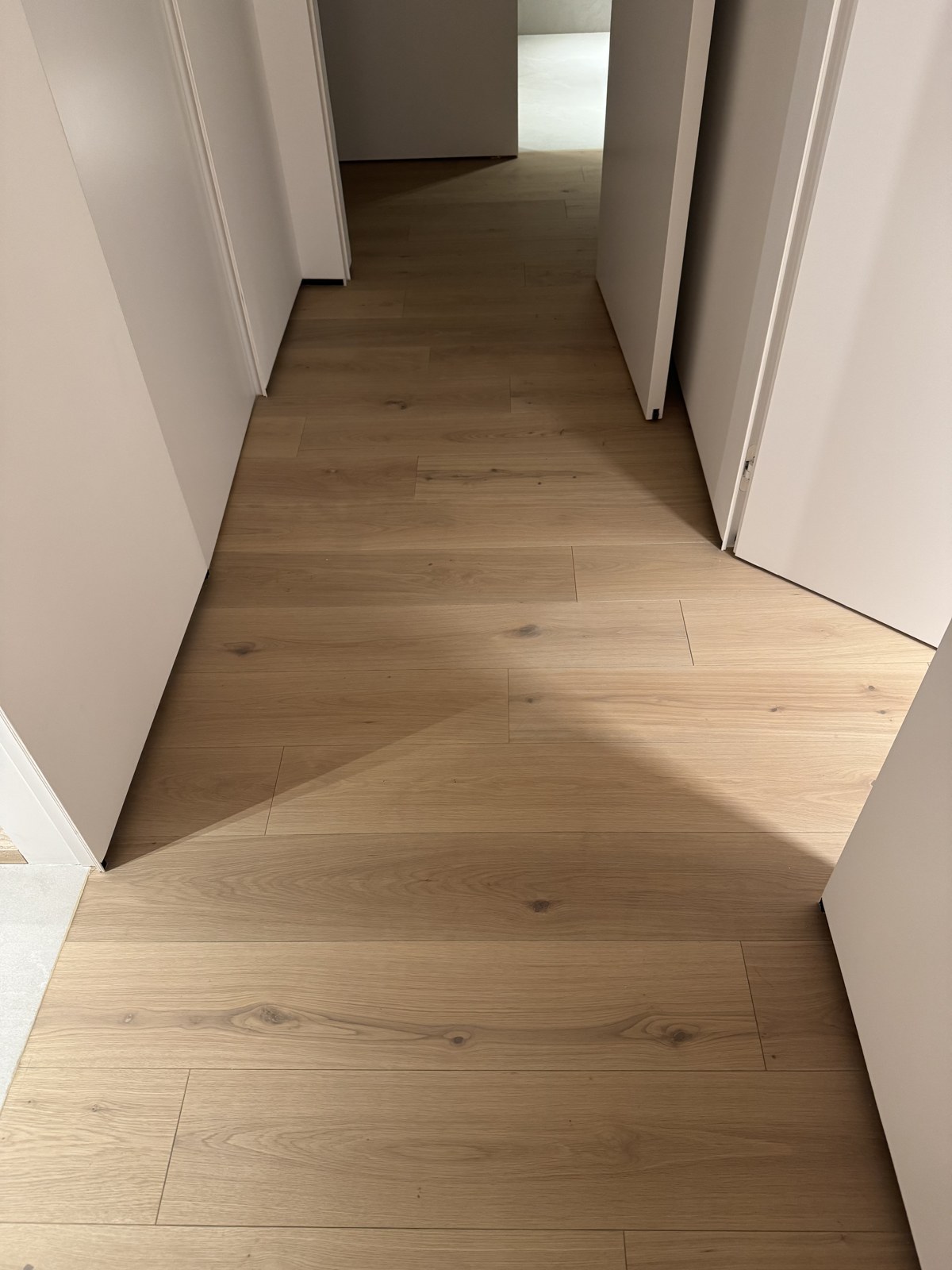 Wooden flooring continuing through doorways without transition strips